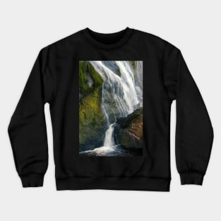 A beautiful waterfall cascades down a mountain in Ireland. Crewneck Sweatshirt